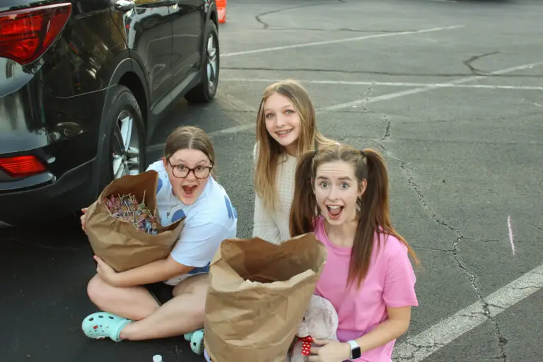 Student girls handing out candy at Fall Festival