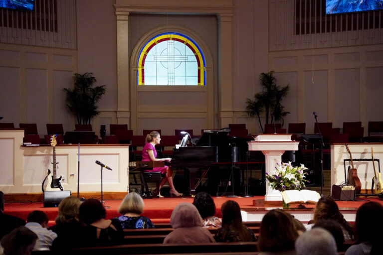 View of pianist on stage from the congregation