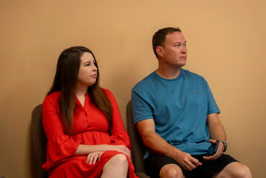 Husband and wife sit together in Sunday School class